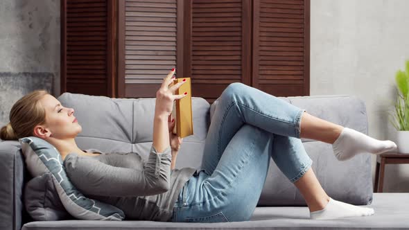 Young woman works with documents using a laptop at home. alt