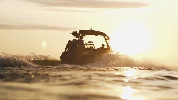 Speed Boat Going On Water Early In The Morning During Sunrise Slow Motion Silhouette Shot