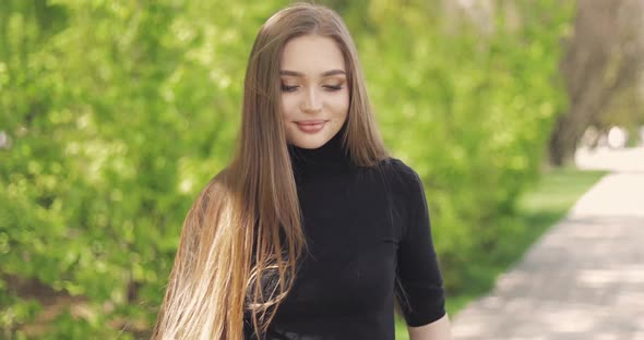 Side View of Pretty Woman Posing Sensually and Smiling at Camera alt