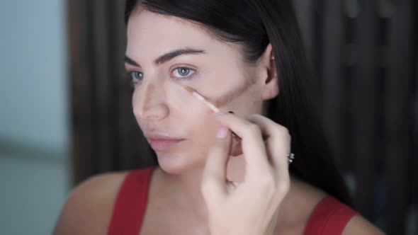 Makeup Artists Apply Highlighter To Raised Areas of Beautiful Young ...