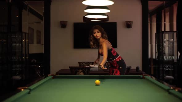 Happy Beautiful Young Woman is Holding Pool Cue