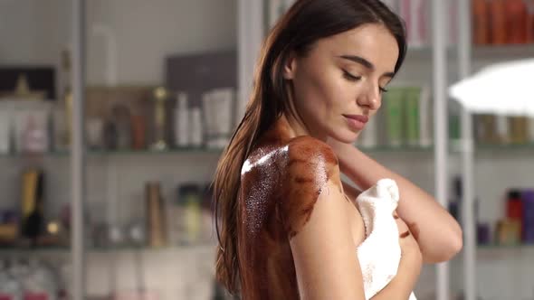 Beautiful Woman at Spa with Chocolate on Her Back alt