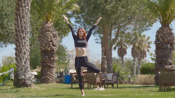 Doing standing yoga exercises. alt