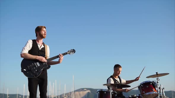 Professional Musicians Play on Instruments, Called Drum Set and Rhythm Guitar alt