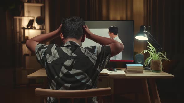 Teenage Boy Headache While Distance Learning With Online Teacher On Computer Screen From Home alt