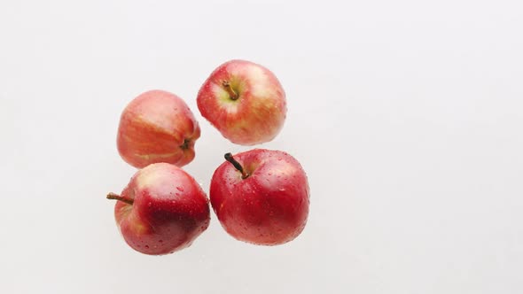 Many Red Apples Filmed on a White Background Jump Up and Flyfor a Tasty Juice alt