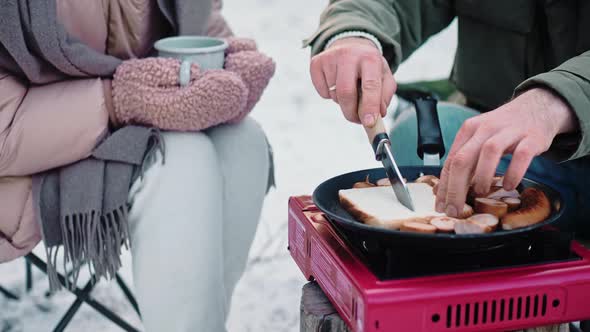 Couple Cooking Lunch at the Camp on a Portable Stove in the Woods