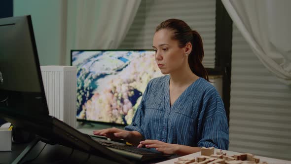 Woman Architect Using Touch Screen for Building Model alt