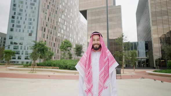 Zoom of Happy Smiling Arabian Man Standing on City Street Looking at Camera alt