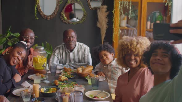 Large African American Family Taking Selfie at Home Dinner alt