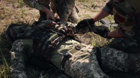 Closeup of a Military Man with a Medical Tourniquet to Prevent Bleeding on His Hand in First Aid alt