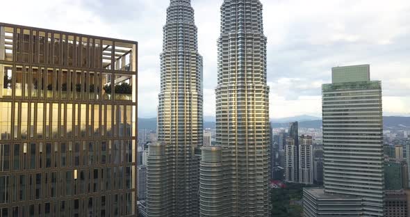 Aerial Footage of the Sunset Reflected in Petronas Twin Towers, Drone Goes Upwards the Building