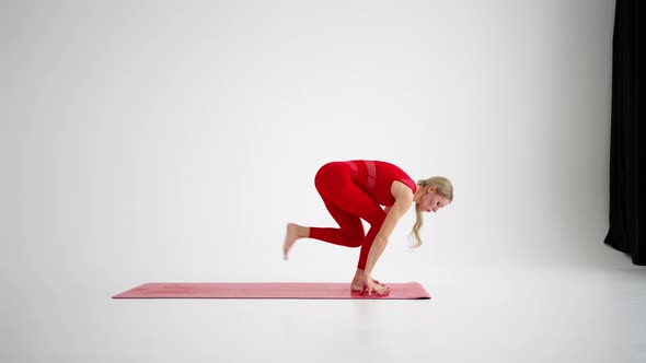 Millennial Woman Stretching in Yoga Pose Meditation Isolated on White Background in Red Sportswear alt