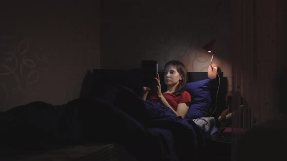 Young Woman Using Her Laptop in Bed