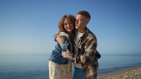 Carefree Couple Hugging Sunny Morning on Beach alt