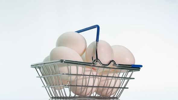 White Chicken Eggs In A Grocery Cart From A Supermarket On A White Background alt