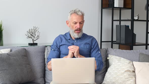 Modern Cheerful Senior Man Using Laptop for Video Connection alt