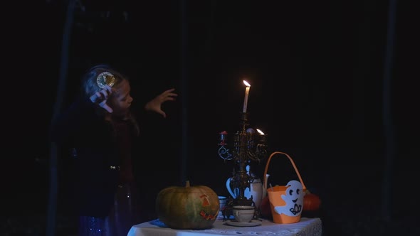 Funny Cute Caucasian Little Girl Making Faces Grimacing on Halloween Night in Darkness in Woodland alt