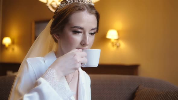 The Bride Drinks Coffee in Her Room in the Morning