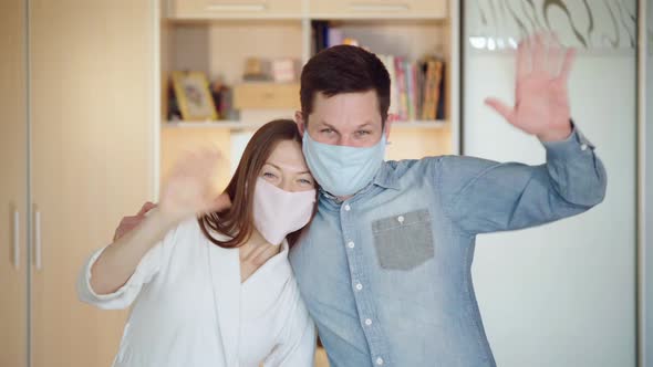 A Couple Has Fun While Quarantining at Home. A Family Wears Masks. Lifestyle During the Lockdown.