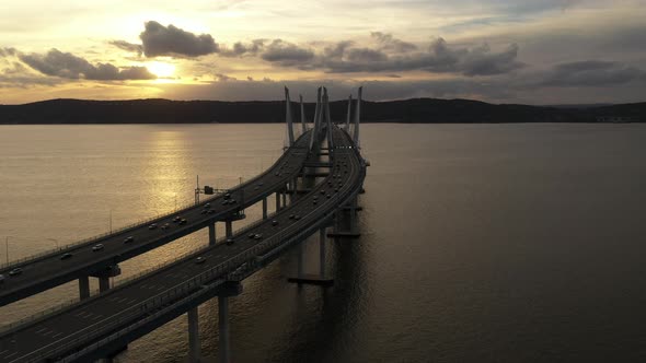 An aerial shot of the Mario M. Cuomo Bridge from the north side. The drone dolly in over the bridge, alt