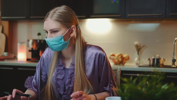 Young Business Woman in Protective Mask Working at Home on Quarantine alt
