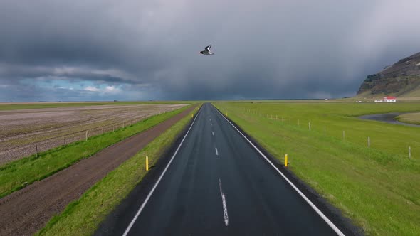 Endless Road Into the Cloudy Mountains and Hills of Iceland During Sunny Cloudy Weather alt