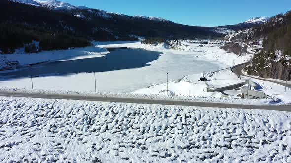 Aerial flying above Tunhovd dam and looking into Tunhovdfjorden water magazine with low fill grade d alt