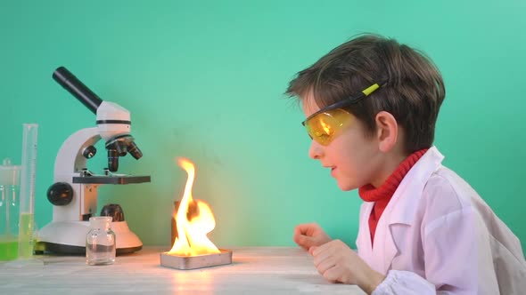 Little Boy is Making Science Experiments with Fire