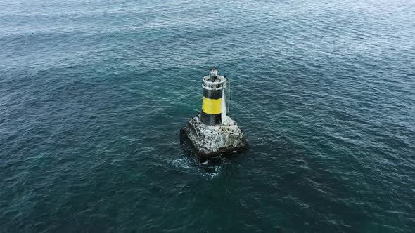 Aerial view of lighthouse in the sea	 alt