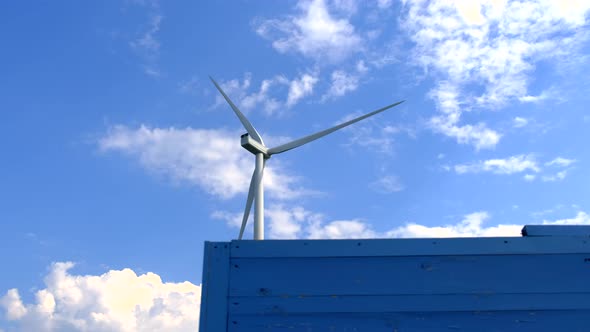 A Windmill That Rotates Under the Influence of Wind and Generates Renewable Energy in an