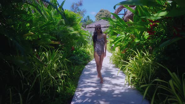 Beautiful Girl In Swimming Suit Walking Alone In Resort in Sunny Day Slow Motion