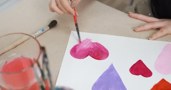 Closeup of Painting Hearts for Cards on Valentine's Day