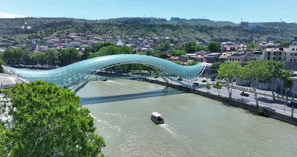 Aerial view of Tbilisi city central park and Bridge of Peace. Beautiful cityscape of old Tbilisi at alt