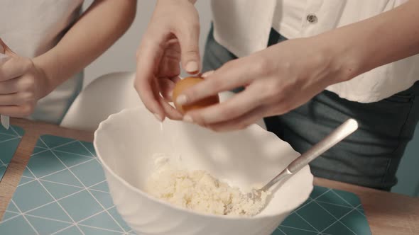Closeup of Female Hands Breaking Raw Egg for Making Dough alt