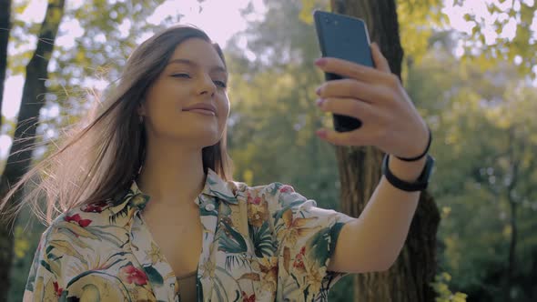 Girl who takes a selfie by the lake