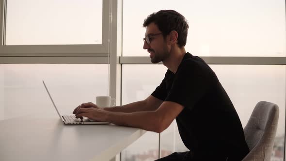 Side View of Business Man Using Laptop Computer at Remote Workplace in Slow Motion alt