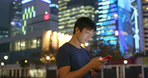 Man use of mobile phone in city at night alt