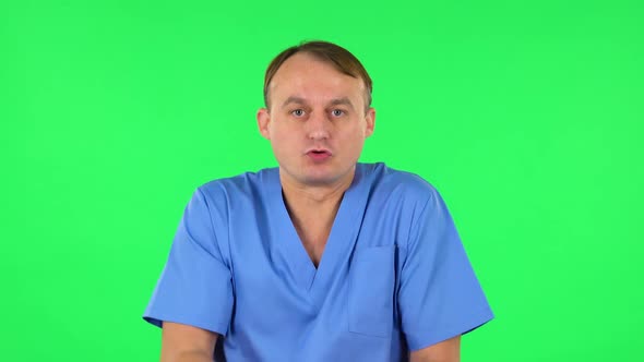 Displeased Man Indignantly Talking To Someone, Looking at the Camera. Green Screen alt