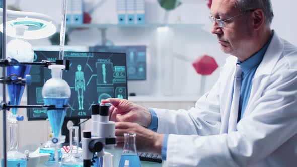 Medium Dolly Shot of Researcher Taking Samples From Tubes alt