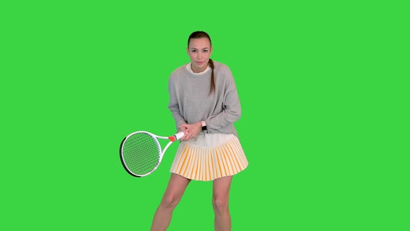 Young Woman Playing Tennis Imitation of a Game on a Green Screen Chroma Key
