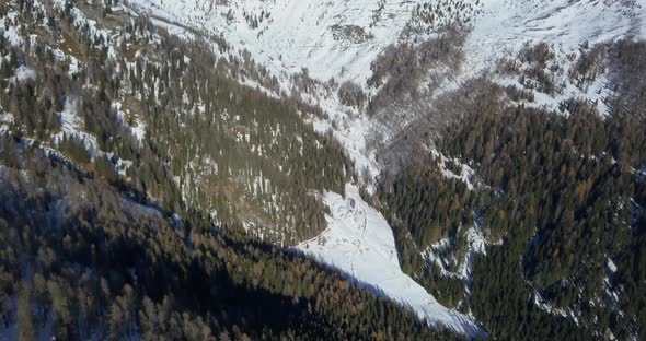 Aerial drone view of snow covered mountains in the winter. alt