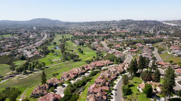 Aerial View of Residential Neighborhood Surrounded By Golf and Valley During Sunny Day in Rancho alt