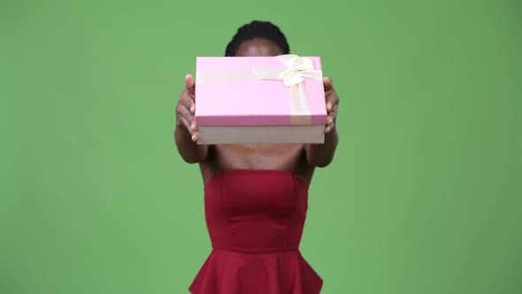 Young Beautiful African Woman Giving Gift Box