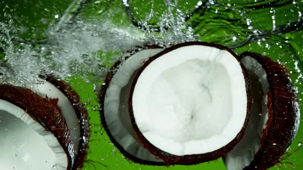 Super Slow Motion Shot of Flying Fresh Coconuts and Water Side Splash at 1000Fps alt