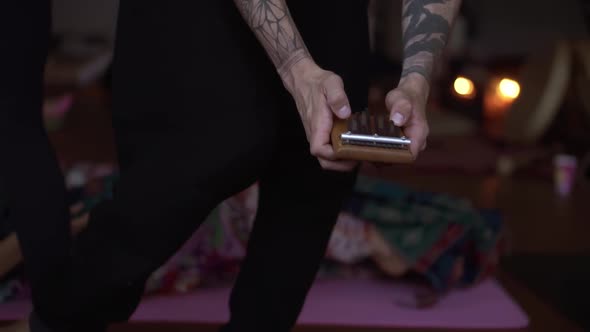 Unrecognizable Man Playing Traditional African Musical Instrument Kalimba for Meditating alt