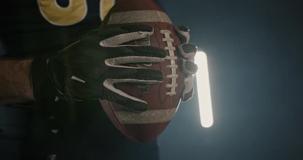 Crop Sportsman with Rugby Ball in Dark Studio