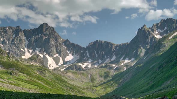 8K Glacial Valley and Alpine Meadow in Front of Rocky Mountain Peaks