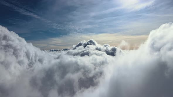 Aerial View From Airplane Window at High Altitude of Earth Covered with White Puffy Cumulus Clouds alt