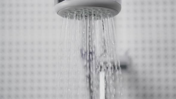 Turning On and Off the Shower Head in Bathroom Water Flowing, Falling Drops in Slow Motion alt